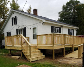 house with wood porch and ramp